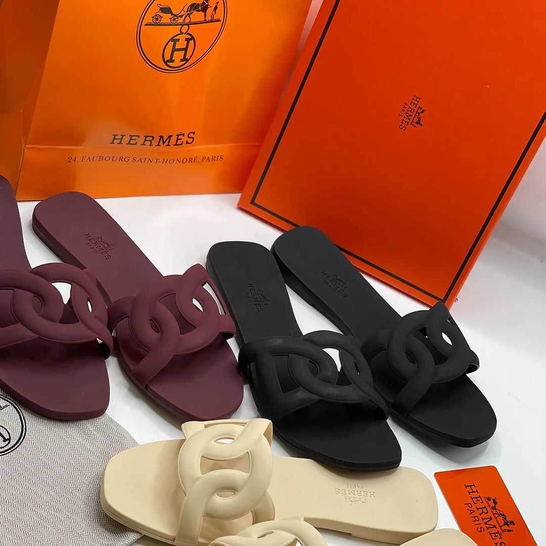 HERMES ALOHA MULES BLACK INTERLOCKING RUBBER FLATS