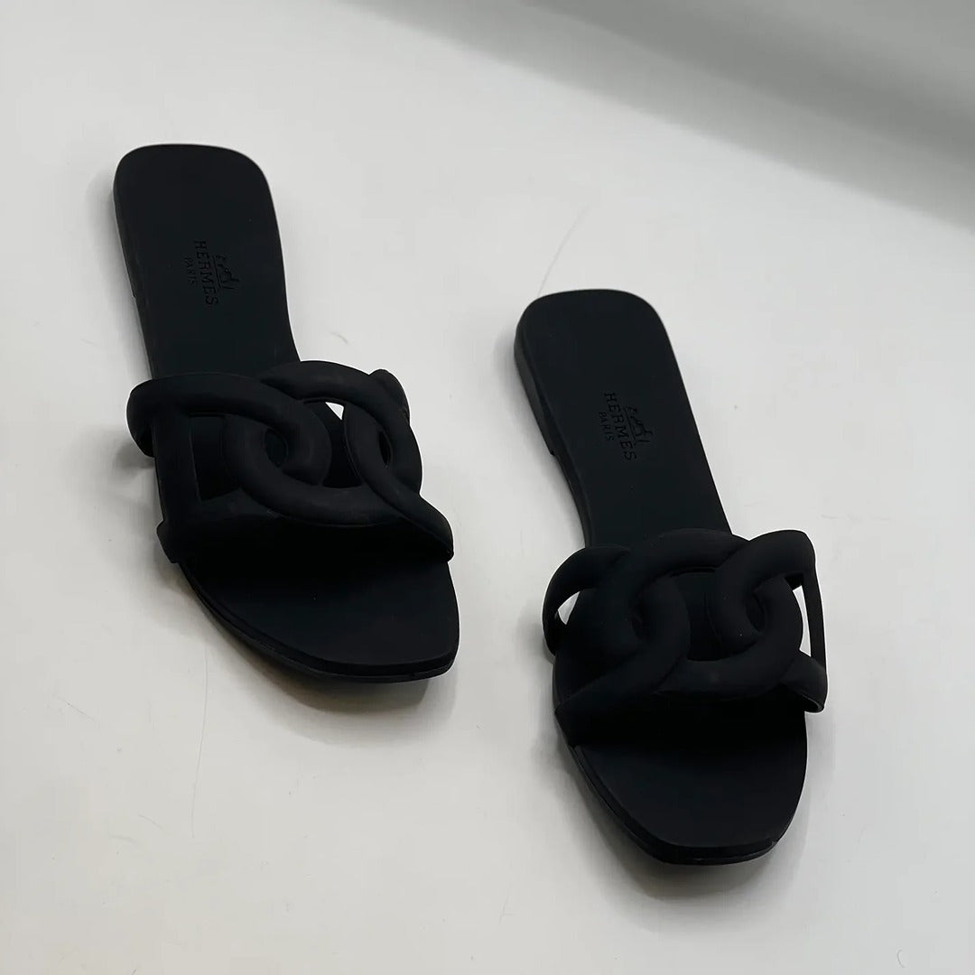 HERMES ALOHA MULES BLACK INTERLOCKING RUBBER FLATS