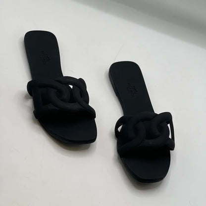 HERMES ALOHA MULES BLACK INTERLOCKING RUBBER FLATS